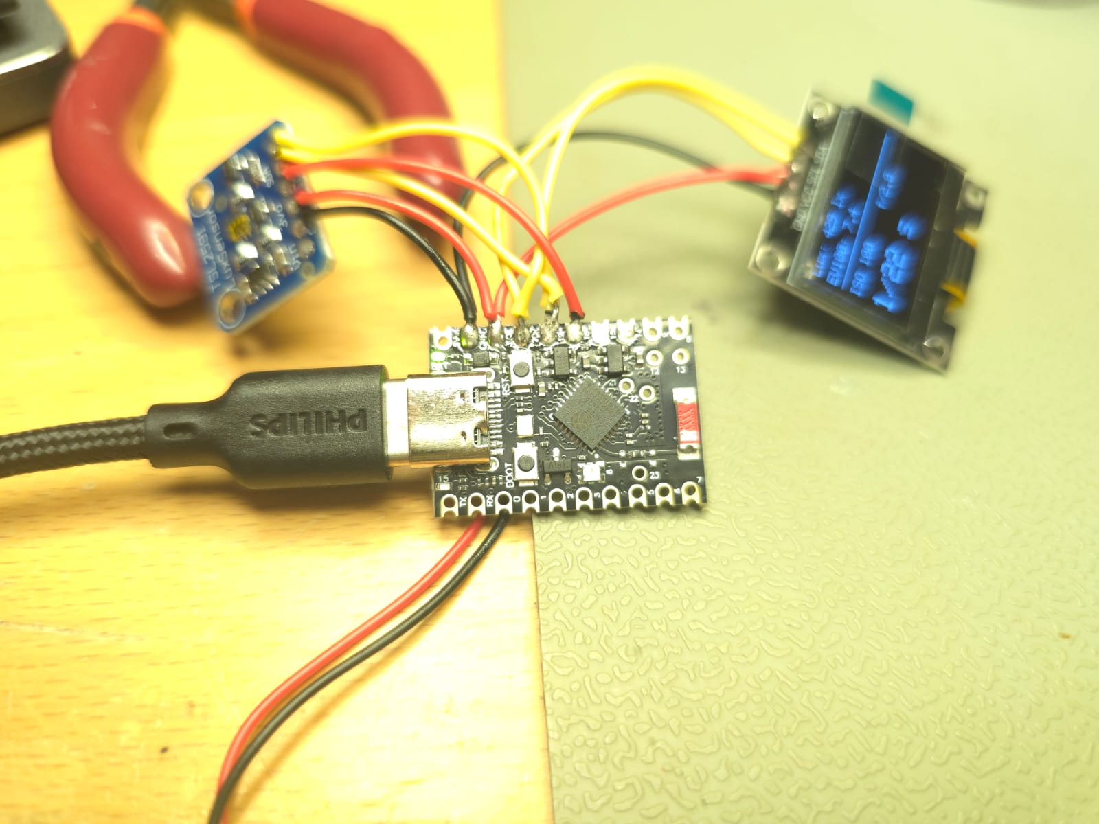 ESP32-C6 prototype board wired to the light sensor and OLED display